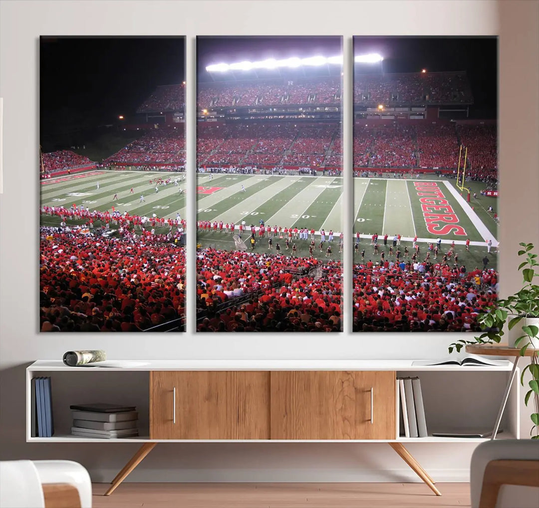 The Rutgers University Scarlet Knights Football Team Print - Piscataway SHI Stadium Wall Art Canvas Print adds an elegant touch to a stylish room. Handmade in the USA, it captures the spirited ambiance of a packed football stadium at night perfectly.