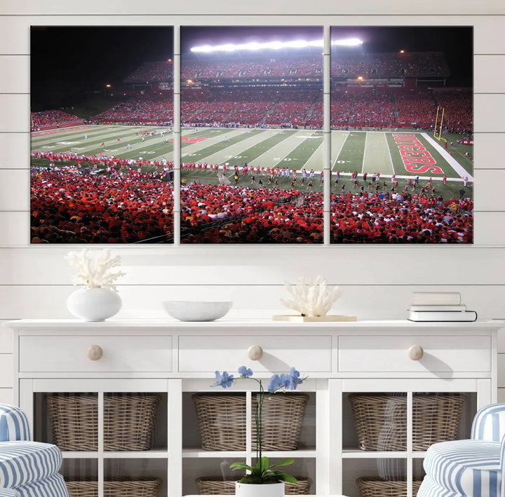 The Rutgers University Scarlet Knights Football Team Print - Piscataway SHI Stadium Wall Art Canvas Print adds an elegant touch to a stylish room. Handmade in the USA, it captures the spirited ambiance of a packed football stadium at night perfectly.