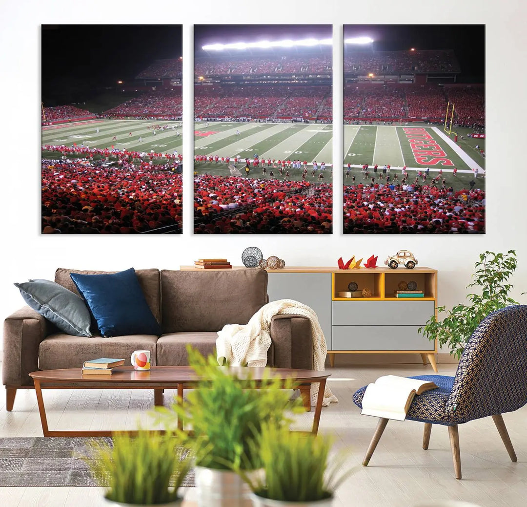 The Rutgers University Scarlet Knights Football Team Print - Piscataway SHI Stadium Wall Art Canvas Print adds an elegant touch to a stylish room. Handmade in the USA, it captures the spirited ambiance of a packed football stadium at night perfectly.