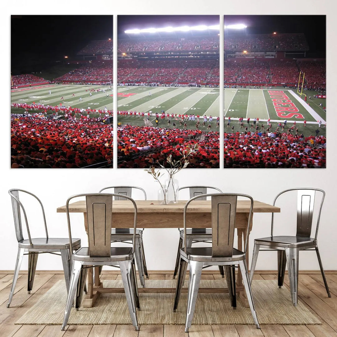 The Rutgers University Scarlet Knights Football Team Print - Piscataway SHI Stadium Wall Art Canvas Print adds an elegant touch to a stylish room. Handmade in the USA, it captures the spirited ambiance of a packed football stadium at night perfectly.