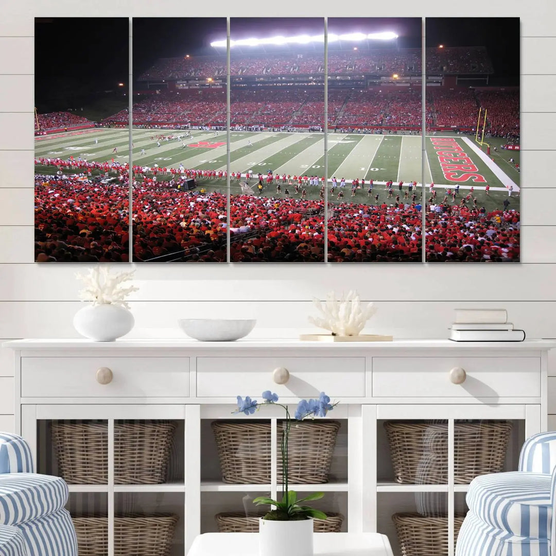 The Rutgers University Scarlet Knights Football Team Print - Piscataway SHI Stadium Wall Art Canvas Print adds an elegant touch to a stylish room. Handmade in the USA, it captures the spirited ambiance of a packed football stadium at night perfectly.