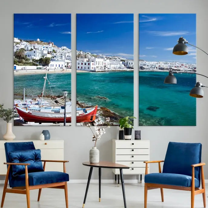 The Santorini Wall Art Canvas Print, showcasing a triptych of a coastal Greek village with white buildings and a turquoise sea, enhances the modern living room.