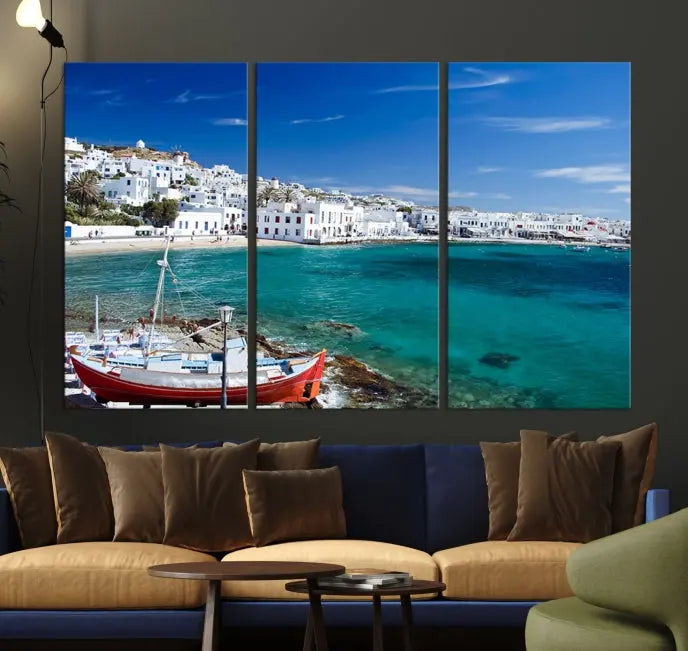 The Santorini Wall Art Canvas Print, showcasing a triptych of a coastal Greek village with white buildings and a turquoise sea, enhances the modern living room.