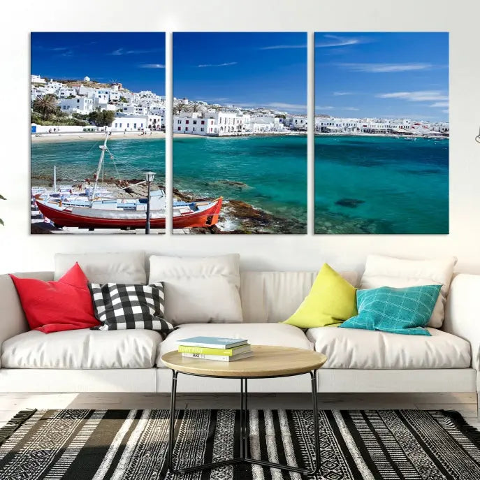 The Santorini Wall Art Canvas Print, showcasing a triptych of a coastal Greek village with white buildings and a turquoise sea, enhances the modern living room.