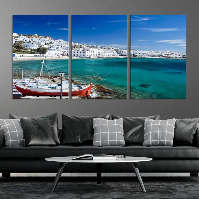 The Santorini Wall Art Canvas Print, showcasing a triptych of a coastal Greek village with white buildings and a turquoise sea, enhances the modern living room.