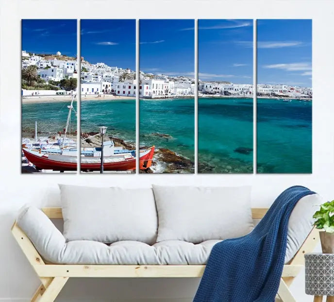 The Santorini Wall Art Canvas Print, showcasing a triptych of a coastal Greek village with white buildings and a turquoise sea, enhances the modern living room.