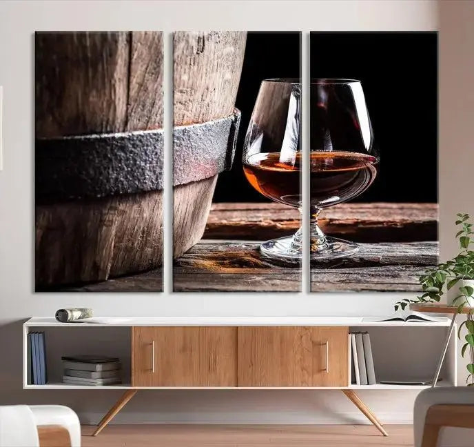 The Scots Whiskey Wall Art Canvas Print, a triptych gallery-wrapped piece crafted with museum-quality precision, showcases a barrel and a glass of whiskey on a wooden table. It includes a UV-protective coating for durability.