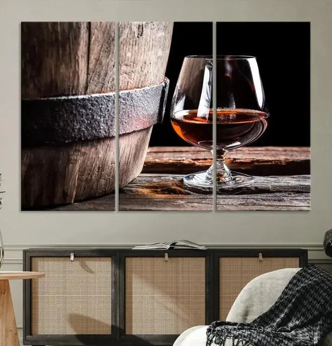 The Scots Whiskey Wall Art Canvas Print, a triptych gallery-wrapped piece crafted with museum-quality precision, showcases a barrel and a glass of whiskey on a wooden table. It includes a UV-protective coating for durability.