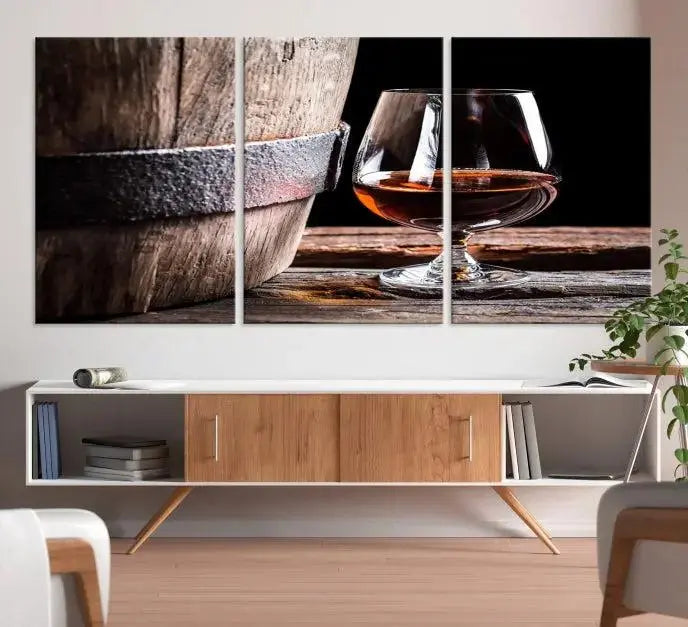 The Scots Whiskey Wall Art Canvas Print, a triptych gallery-wrapped piece crafted with museum-quality precision, showcases a barrel and a glass of whiskey on a wooden table. It includes a UV-protective coating for durability.