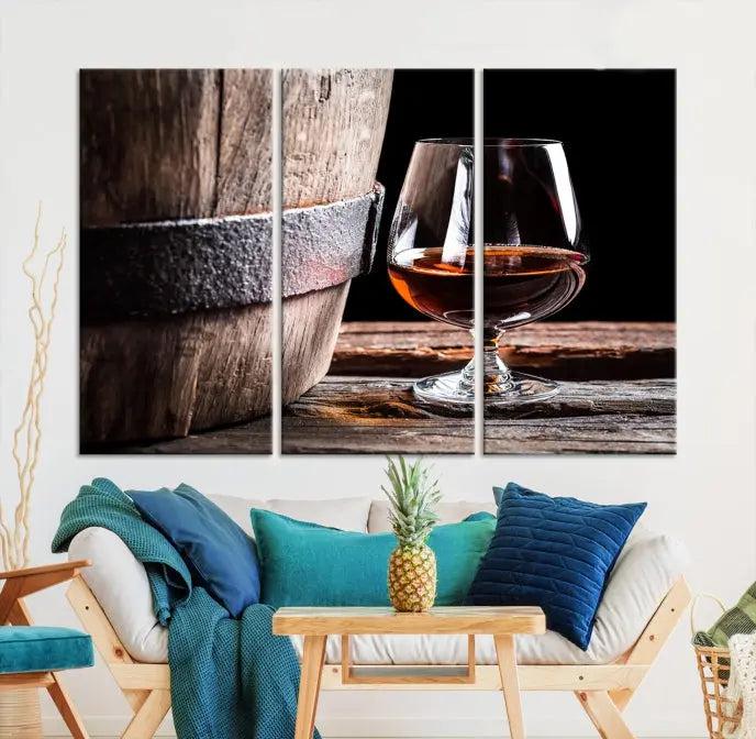 The Scots Whiskey Wall Art Canvas Print, a triptych gallery-wrapped piece crafted with museum-quality precision, showcases a barrel and a glass of whiskey on a wooden table. It includes a UV-protective coating for durability.