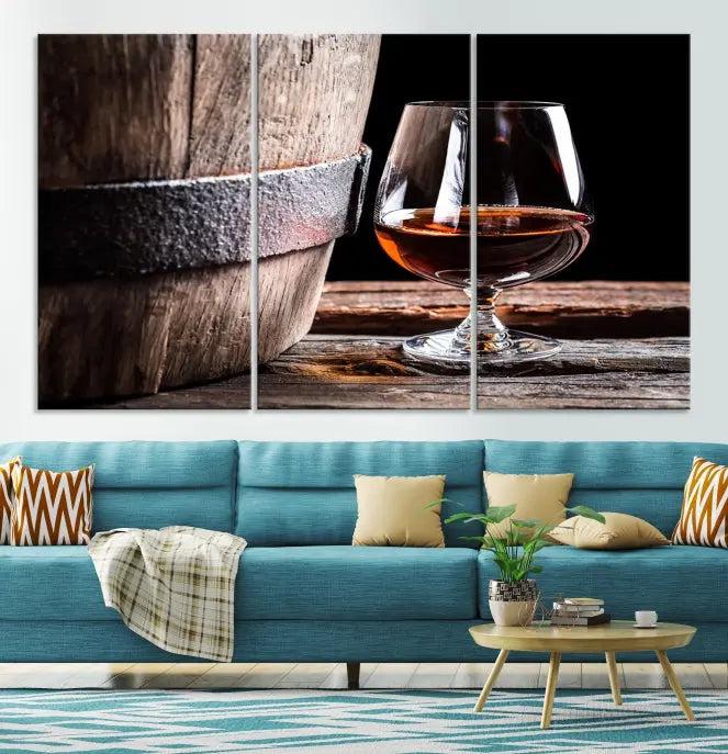 The Scots Whiskey Wall Art Canvas Print, a triptych gallery-wrapped piece crafted with museum-quality precision, showcases a barrel and a glass of whiskey on a wooden table. It includes a UV-protective coating for durability.