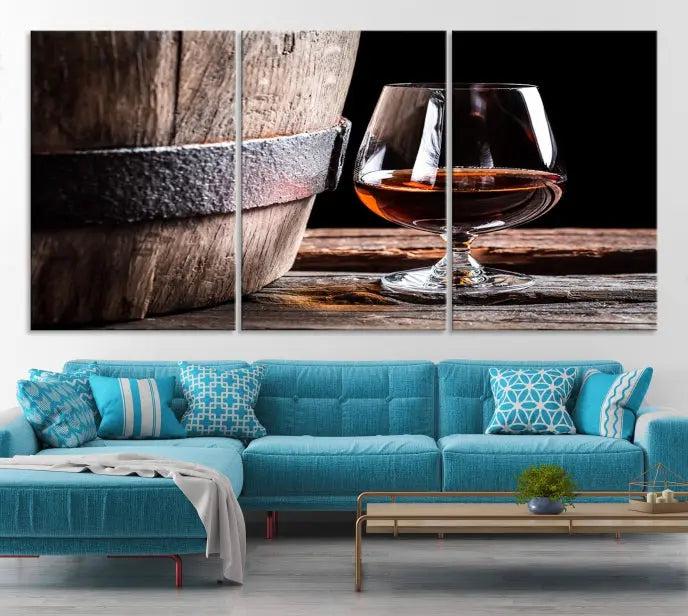 The Scots Whiskey Wall Art Canvas Print, a triptych gallery-wrapped piece crafted with museum-quality precision, showcases a barrel and a glass of whiskey on a wooden table. It includes a UV-protective coating for durability.