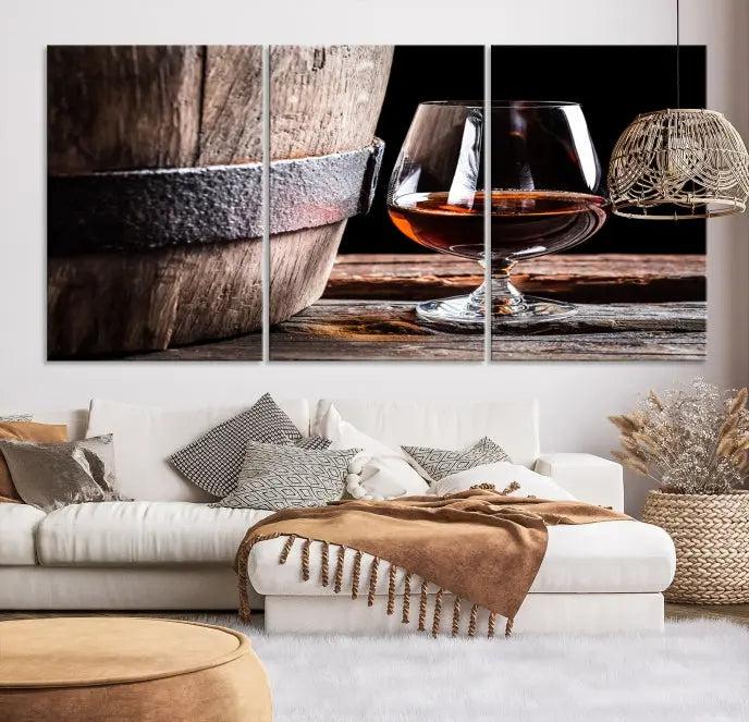 The Scots Whiskey Wall Art Canvas Print, a triptych gallery-wrapped piece crafted with museum-quality precision, showcases a barrel and a glass of whiskey on a wooden table. It includes a UV-protective coating for durability.