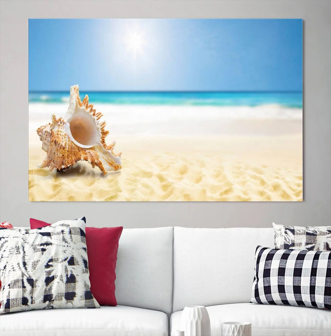 The Sea Shell on The Beach Sun Sand Wall Art Canvas Print is a triptych that beautifully captures a beach scene with a large seashell on the sand.