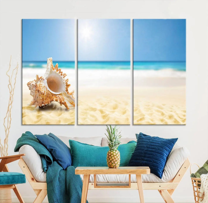 The Sea Shell on The Beach Sun Sand Wall Art Canvas Print is a triptych that beautifully captures a beach scene with a large seashell on the sand.