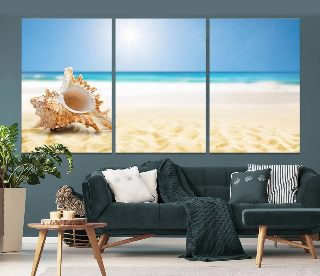 The Sea Shell on The Beach Sun Sand Wall Art Canvas Print is a triptych that beautifully captures a beach scene with a large seashell on the sand.