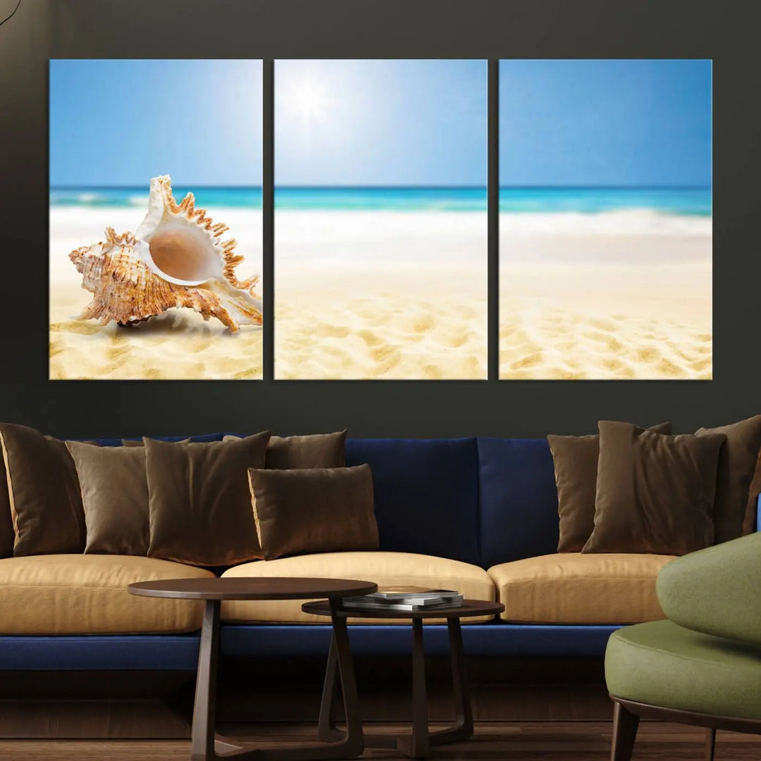 The Sea Shell on The Beach Sun Sand Wall Art Canvas Print is a triptych that beautifully captures a beach scene with a large seashell on the sand.