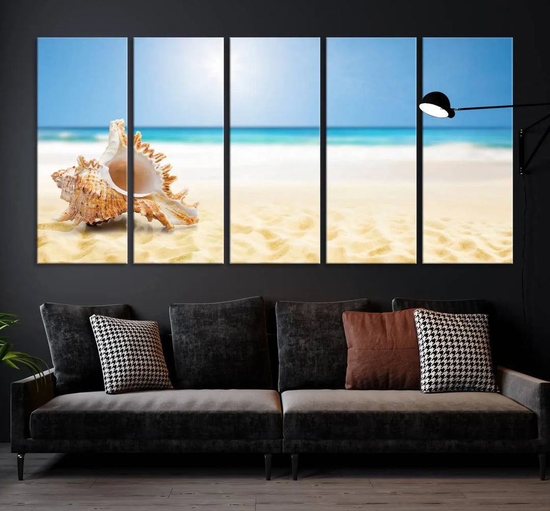 The Sea Shell on The Beach Sun Sand Wall Art Canvas Print is a triptych that beautifully captures a beach scene with a large seashell on the sand.