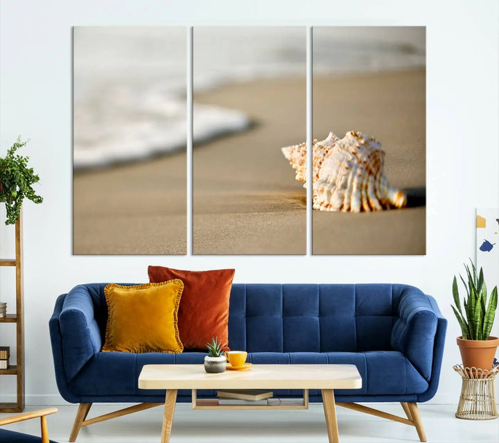 The triptych artwork titled "Sea Shell on the Beach Canvas Wall Art Beach Canvas Print" showcases a seashell on a sandy beach with ocean waves in the background, creating a stunning piece of coastal wall decor.