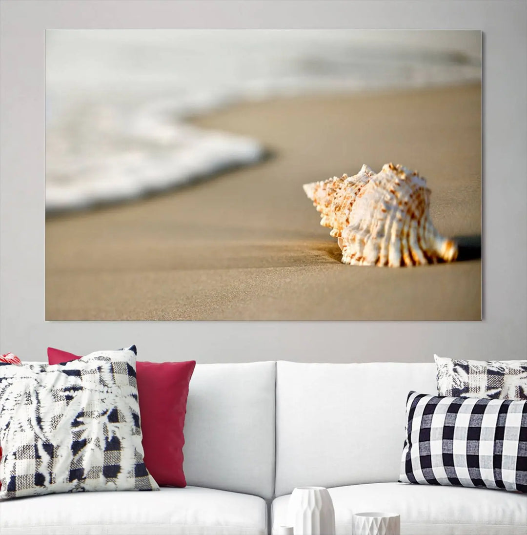 The triptych artwork titled "Sea Shell on the Beach Canvas Wall Art Beach Canvas Print" showcases a seashell on a sandy beach with ocean waves in the background, creating a stunning piece of coastal wall decor.