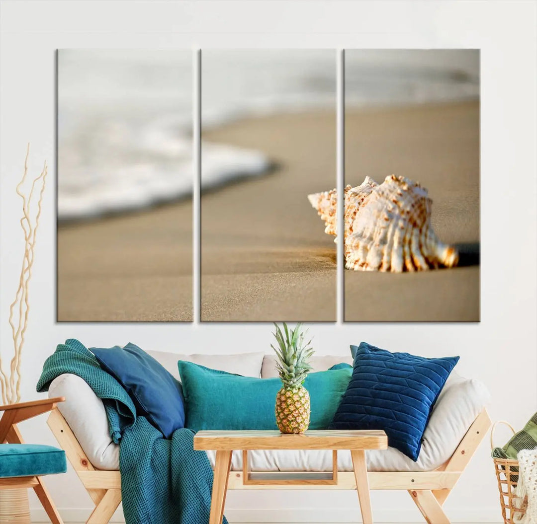 The triptych artwork titled "Sea Shell on the Beach Canvas Wall Art Beach Canvas Print" showcases a seashell on a sandy beach with ocean waves in the background, creating a stunning piece of coastal wall decor.