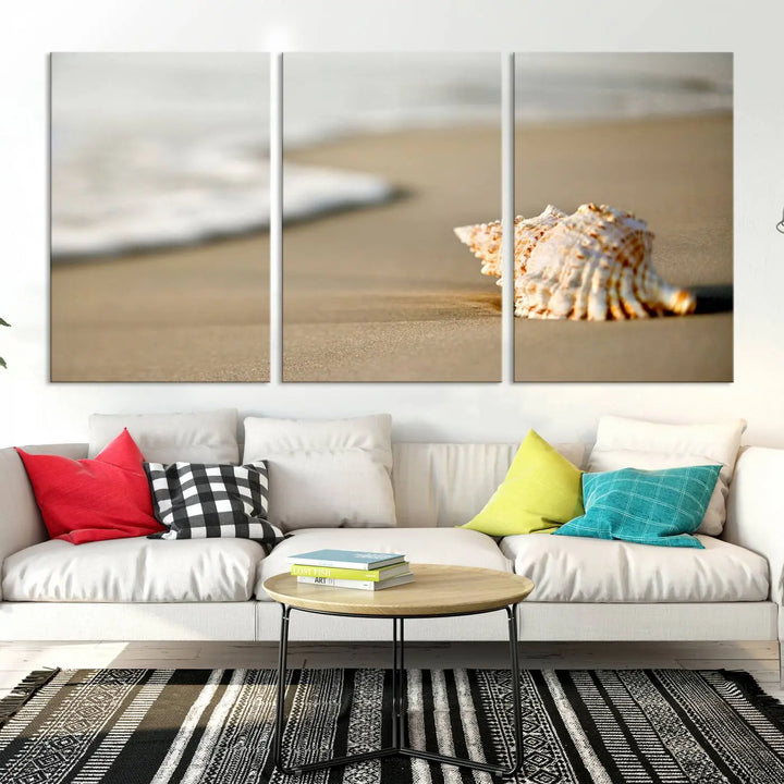 The triptych artwork titled "Sea Shell on the Beach Canvas Wall Art Beach Canvas Print" showcases a seashell on a sandy beach with ocean waves in the background, creating a stunning piece of coastal wall decor.