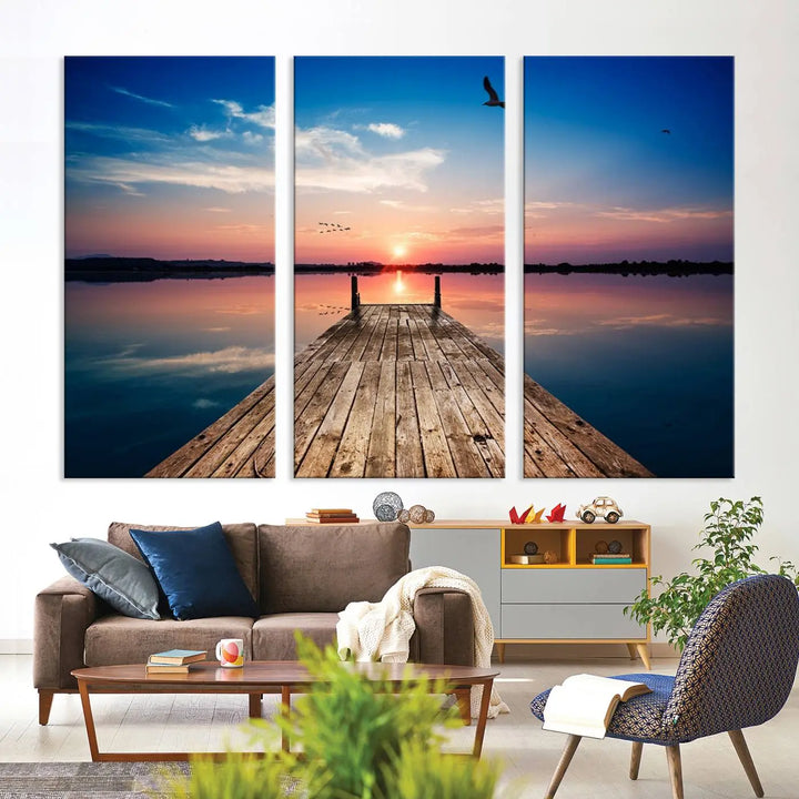 A Sea Wooden Pier Canvas Wall Art, featuring a sunset artwork print of the beach, fosters a coastal ambiance in the modern living room.