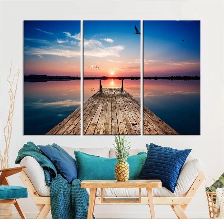 A Sea Wooden Pier Canvas Wall Art, featuring a sunset artwork print of the beach, fosters a coastal ambiance in the modern living room.