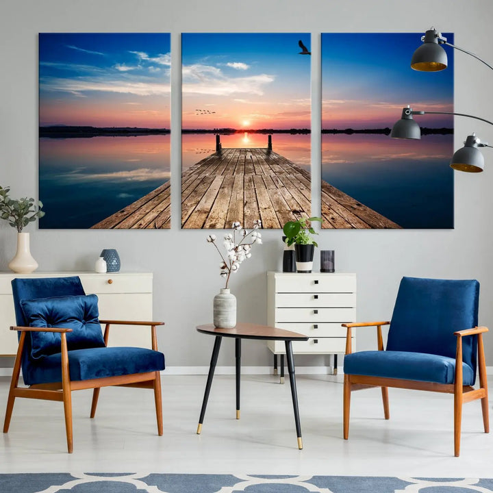 A Sea Wooden Pier Canvas Wall Art, featuring a sunset artwork print of the beach, fosters a coastal ambiance in the modern living room.