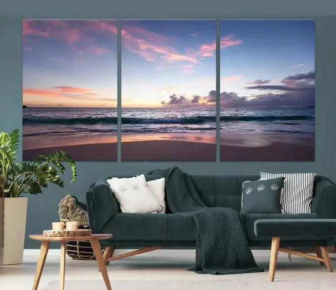 A triptych of the "Sea and Beach Wall Art Canvas Print" hangs elegantly in the modern living room. The gallery-wrapped artwork, printed on museum-quality canvas, is beautifully enhanced by its elegantly hand-assembled frame, adding an elegant touch to the space.