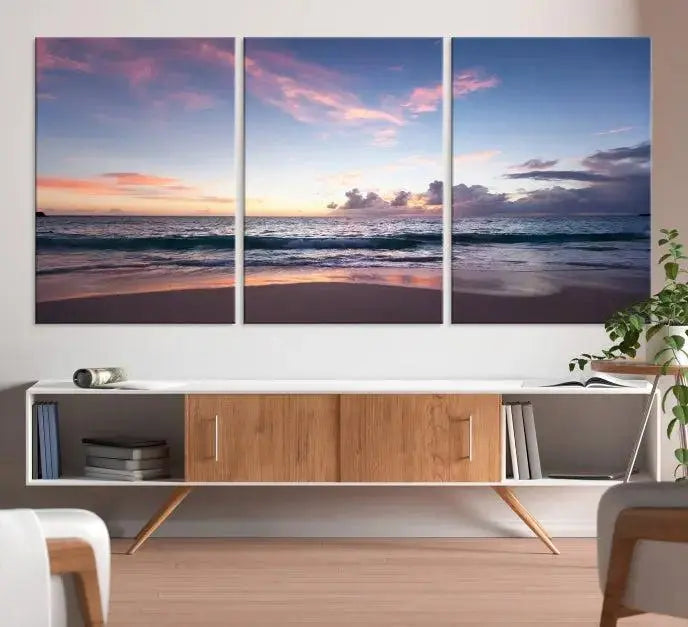 A triptych of the "Sea and Beach Wall Art Canvas Print" hangs elegantly in the modern living room. The gallery-wrapped artwork, printed on museum-quality canvas, is beautifully enhanced by its elegantly hand-assembled frame, adding an elegant touch to the space.