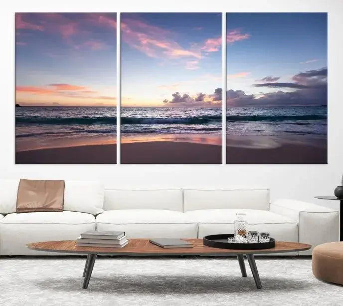 A triptych of the "Sea and Beach Wall Art Canvas Print" hangs elegantly in the modern living room. The gallery-wrapped artwork, printed on museum-quality canvas, is beautifully enhanced by its elegantly hand-assembled frame, adding an elegant touch to the space.