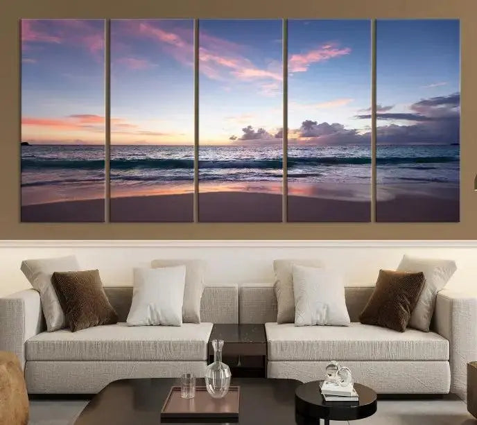 A triptych of the "Sea and Beach Wall Art Canvas Print" hangs elegantly in the modern living room. The gallery-wrapped artwork, printed on museum-quality canvas, is beautifully enhanced by its elegantly hand-assembled frame, adding an elegant touch to the space.