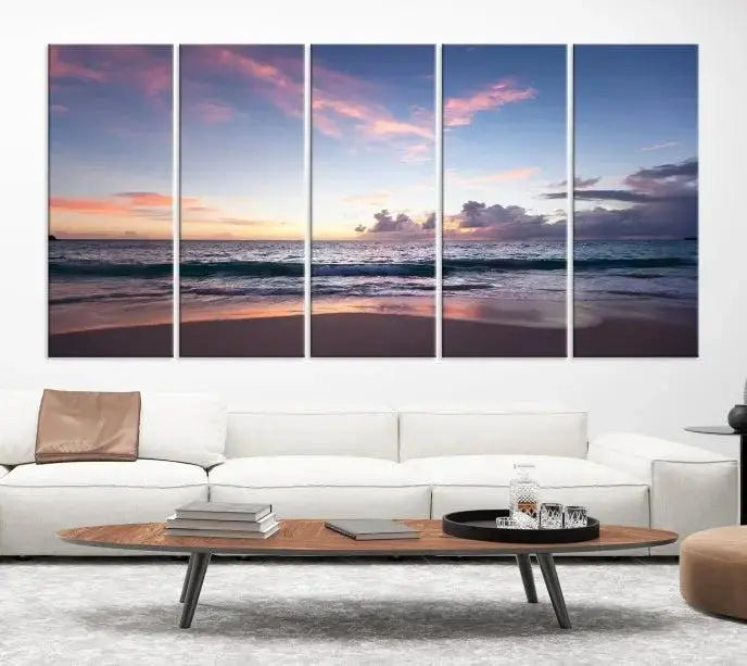 A triptych of the "Sea and Beach Wall Art Canvas Print" hangs elegantly in the modern living room. The gallery-wrapped artwork, printed on museum-quality canvas, is beautifully enhanced by its elegantly hand-assembled frame, adding an elegant touch to the space.