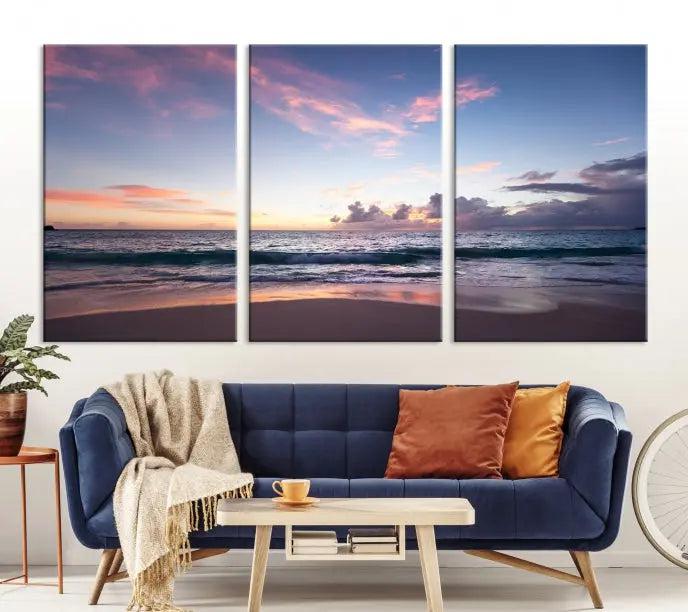 A triptych of the "Sea and Beach Wall Art Canvas Print" hangs elegantly in the modern living room. The gallery-wrapped artwork, printed on museum-quality canvas, is beautifully enhanced by its elegantly hand-assembled frame, adding an elegant touch to the space.