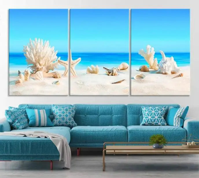 The Seashell Wall Art Canvas Print features a triptych of a beach scene, complete with coral, starfish, and seashells on sand. Printed on museum-quality canvas with UV-protective coating, it is ready to hang and brings vibrant charm to any living room.