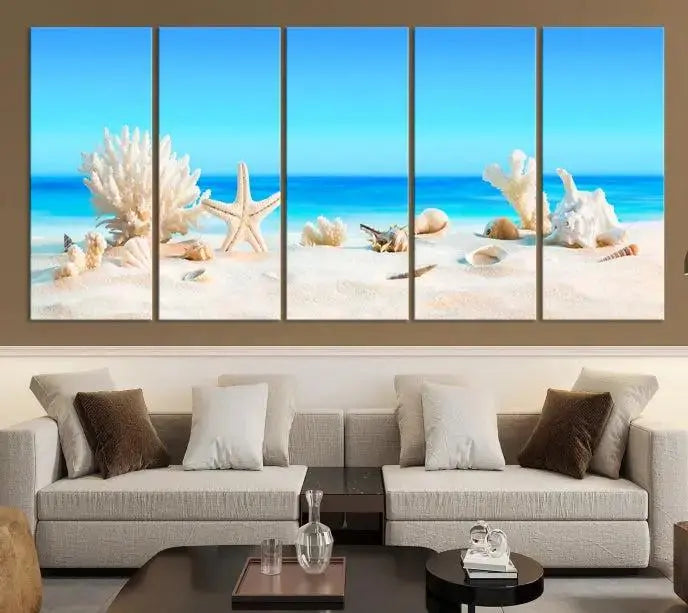 The Seashell Wall Art Canvas Print features a triptych of a beach scene, complete with coral, starfish, and seashells on sand. Printed on museum-quality canvas with UV-protective coating, it is ready to hang and brings vibrant charm to any living room.