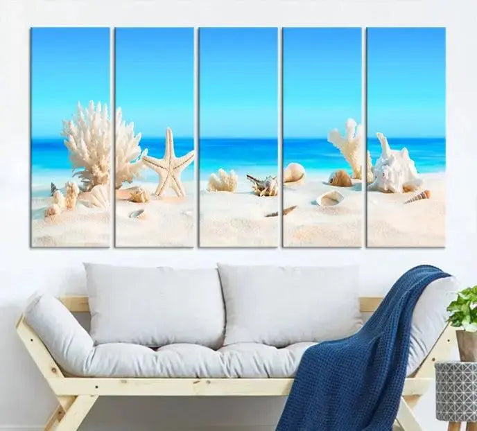 The Seashell Wall Art Canvas Print features a triptych of a beach scene, complete with coral, starfish, and seashells on sand. Printed on museum-quality canvas with UV-protective coating, it is ready to hang and brings vibrant charm to any living room.