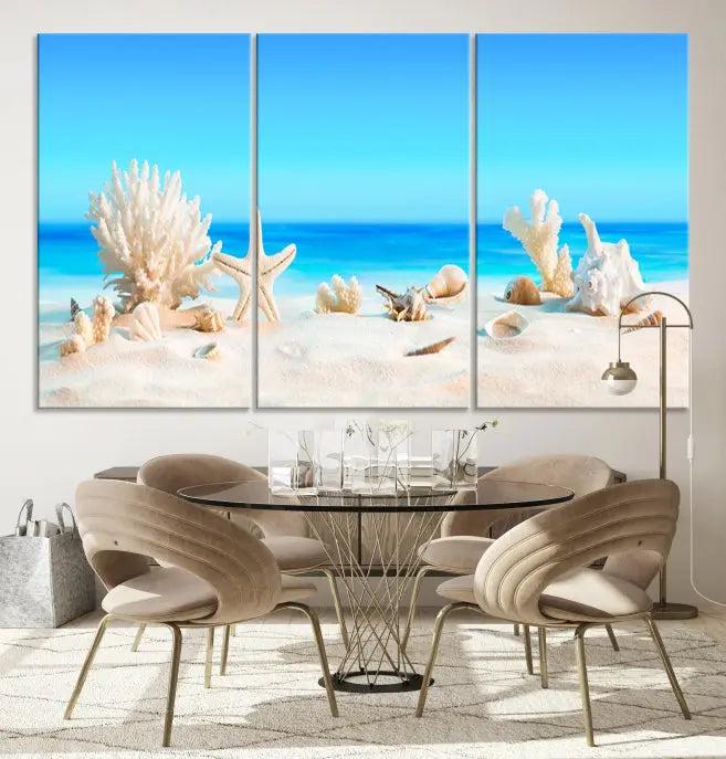 The Seashell Wall Art Canvas Print features a triptych of a beach scene, complete with coral, starfish, and seashells on sand. Printed on museum-quality canvas with UV-protective coating, it is ready to hang and brings vibrant charm to any living room.