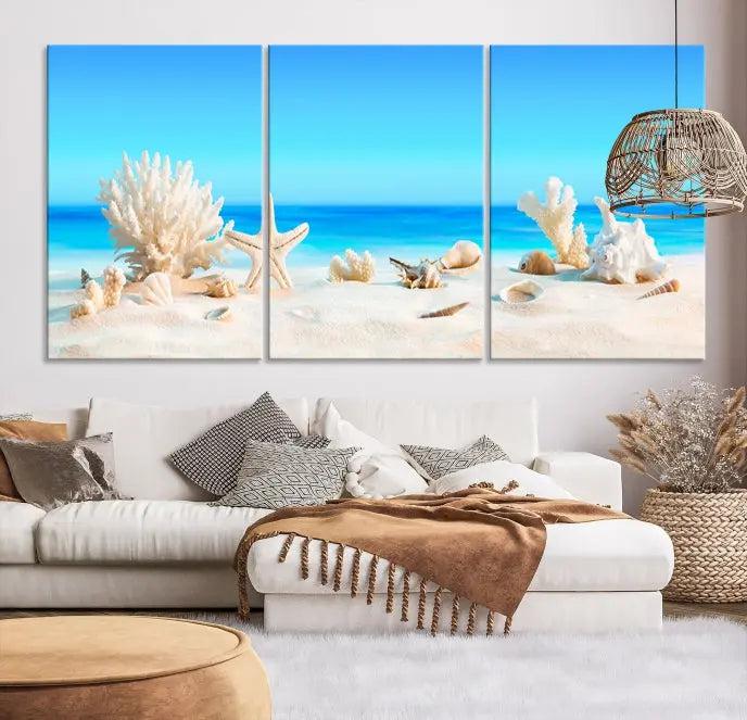 The Seashell Wall Art Canvas Print features a triptych of a beach scene, complete with coral, starfish, and seashells on sand. Printed on museum-quality canvas with UV-protective coating, it is ready to hang and brings vibrant charm to any living room.