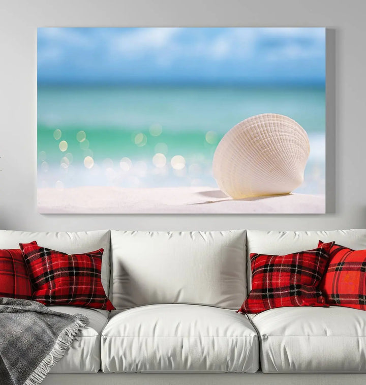 The "Seashell on The Beach Wall Art Canvas Print" features a triptych photo of a seashell on a sandy beach. This artwork is printed on gallery-wrapped, museum-quality canvas with a UV-protective coating.