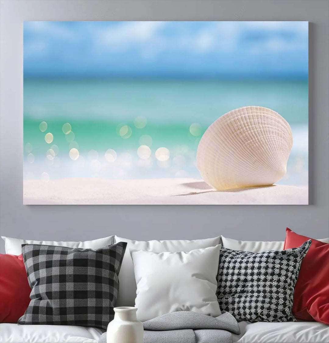 The "Seashell on The Beach Wall Art Canvas Print" features a triptych photo of a seashell on a sandy beach. This artwork is printed on gallery-wrapped, museum-quality canvas with a UV-protective coating.