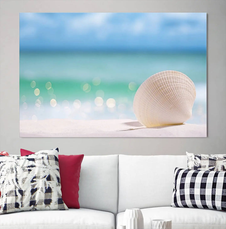 The "Seashell on The Beach Wall Art Canvas Print" features a triptych photo of a seashell on a sandy beach. This artwork is printed on gallery-wrapped, museum-quality canvas with a UV-protective coating.