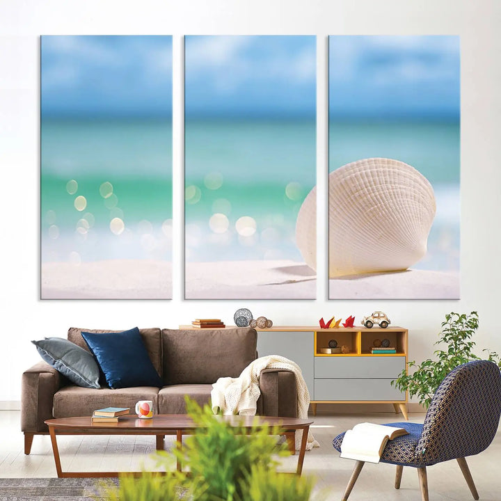 The "Seashell on The Beach Wall Art Canvas Print" features a triptych photo of a seashell on a sandy beach. This artwork is printed on gallery-wrapped, museum-quality canvas with a UV-protective coating.