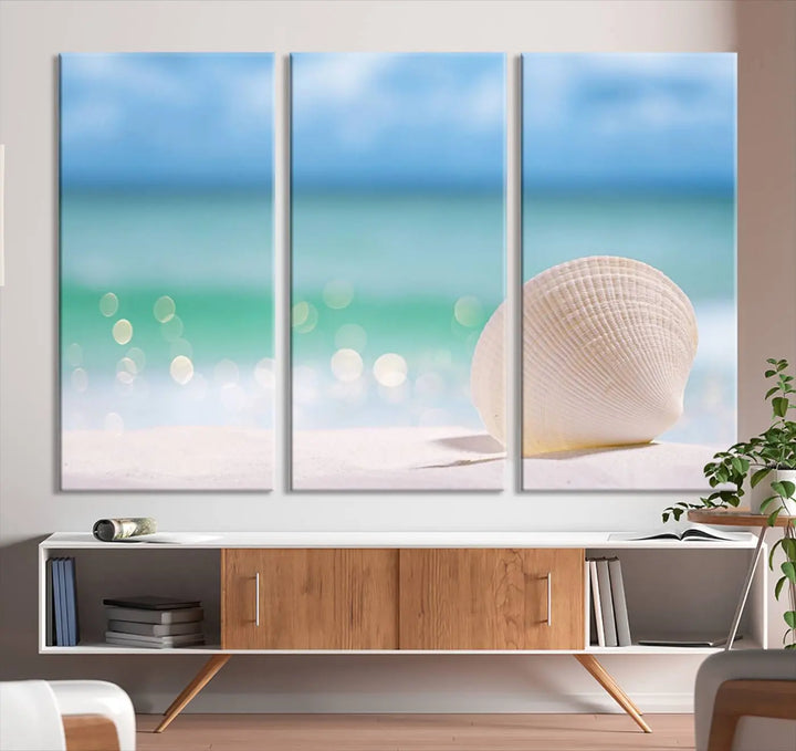 The "Seashell on The Beach Wall Art Canvas Print" features a triptych photo of a seashell on a sandy beach. This artwork is printed on gallery-wrapped, museum-quality canvas with a UV-protective coating.