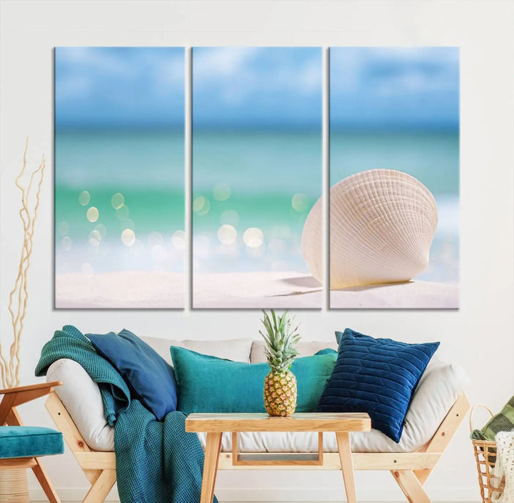 The "Seashell on The Beach Wall Art Canvas Print" features a triptych photo of a seashell on a sandy beach. This artwork is printed on gallery-wrapped, museum-quality canvas with a UV-protective coating.