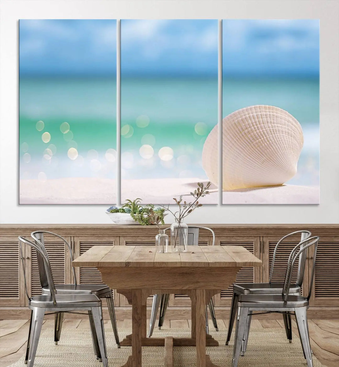 The "Seashell on The Beach Wall Art Canvas Print" features a triptych photo of a seashell on a sandy beach. This artwork is printed on gallery-wrapped, museum-quality canvas with a UV-protective coating.