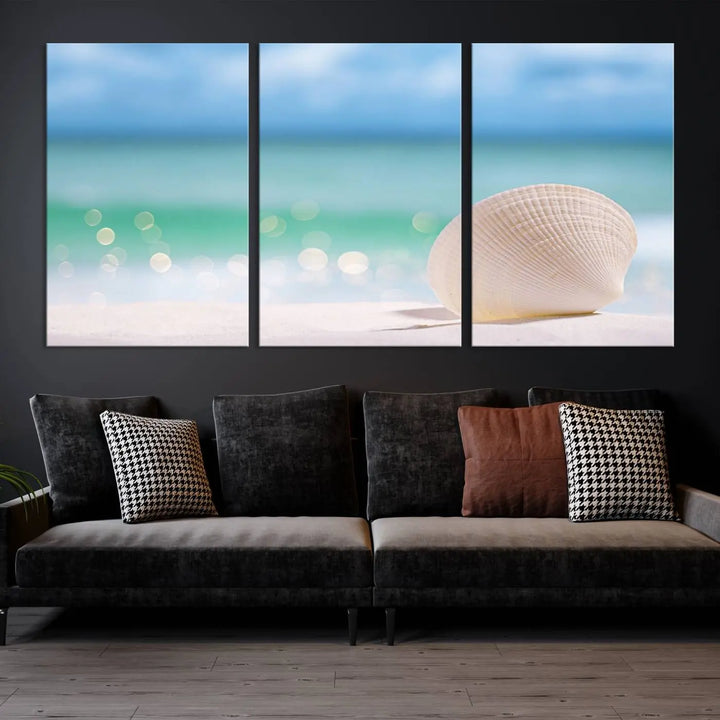 The "Seashell on The Beach Wall Art Canvas Print" features a triptych photo of a seashell on a sandy beach. This artwork is printed on gallery-wrapped, museum-quality canvas with a UV-protective coating.