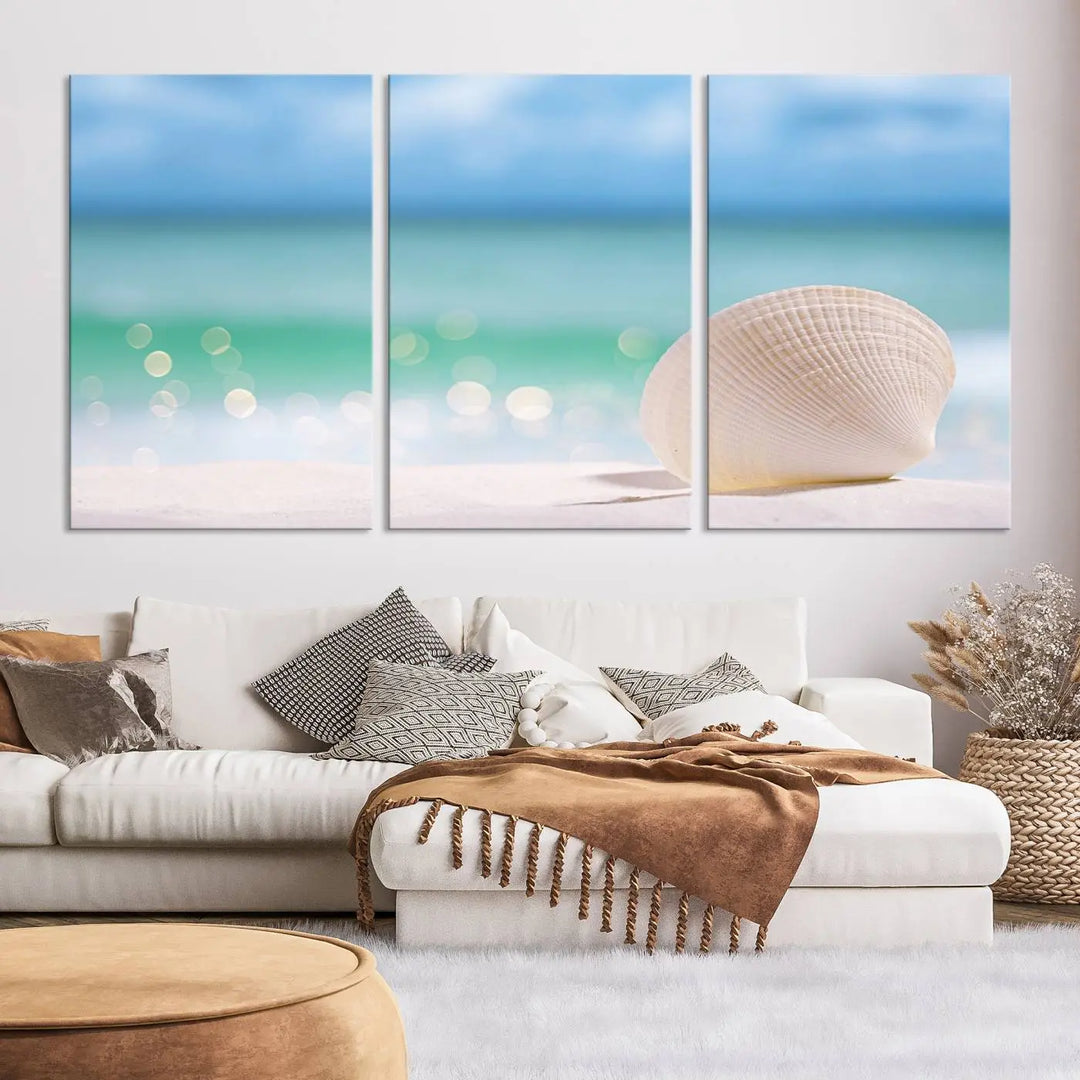 The "Seashell on The Beach Wall Art Canvas Print" features a triptych photo of a seashell on a sandy beach. This artwork is printed on gallery-wrapped, museum-quality canvas with a UV-protective coating.