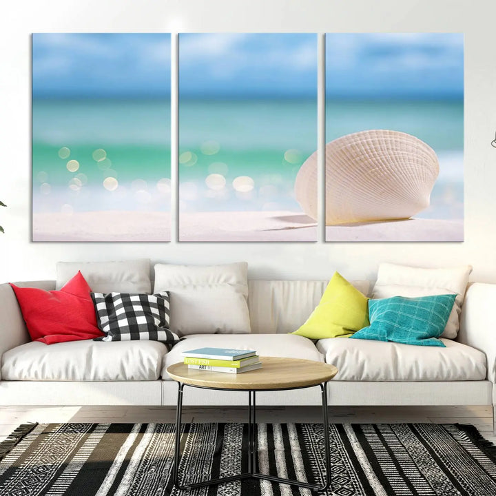 The "Seashell on The Beach Wall Art Canvas Print" features a triptych photo of a seashell on a sandy beach. This artwork is printed on gallery-wrapped, museum-quality canvas with a UV-protective coating.